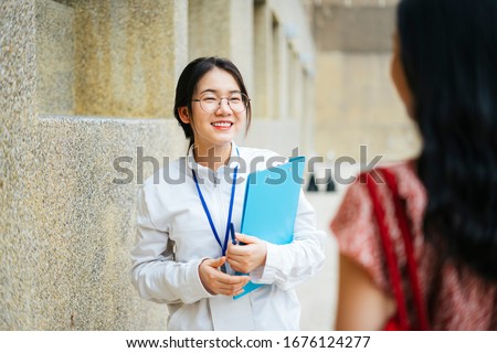 Beautiful asian woman tour guide talking to traveler and giving travel infomation. Royalty-Free Stock Photo #1676124277