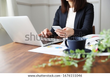 A woman in a suit doing telework at home Royalty-Free Stock Photo #1676151046