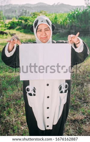 Young female lady holding white paper wearing animal costume