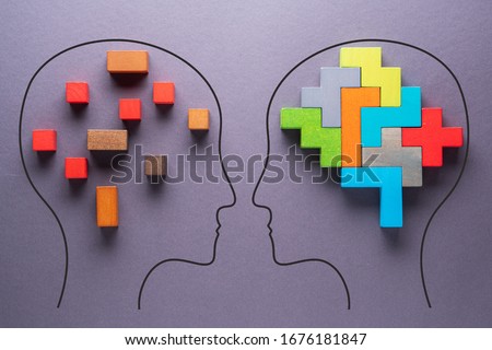 The concept of rational and irrational thinking of two people. Heads of two people with colourful shapes of abstract brain for concept of idea and teamwork on gray background. Different thinking.  Royalty-Free Stock Photo #1676181847