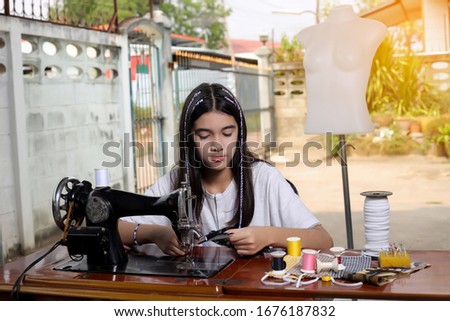 Asian Girl are using mask production sewing machines to prevent the flu. Covid-19 in thailand