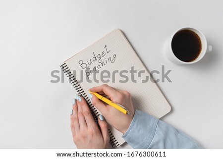 Top view of notebook with Budget planning. Concept of family budget.