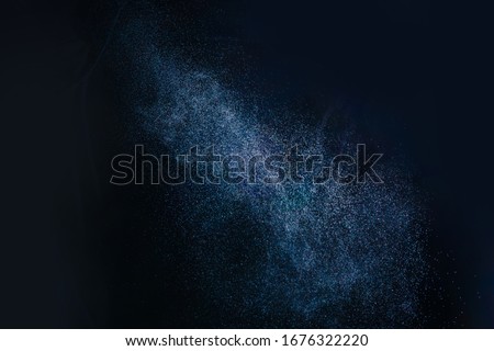 Water Spray against Black Background. Aerosol Sprays Small Drops of Water. Slow Motion in 120 fps. Spray the liquid in the air. Micro drops of water fly in the air. Royalty-Free Stock Photo #1676322220