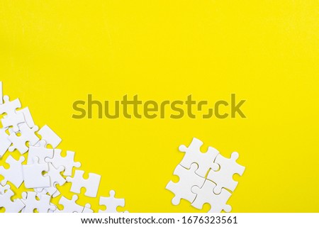 Jigsaw puzzles on the yellow background