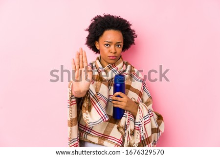 Middle age african american woman in a camping isolatedstanding with outstretched hand showing stop sign, preventing you.