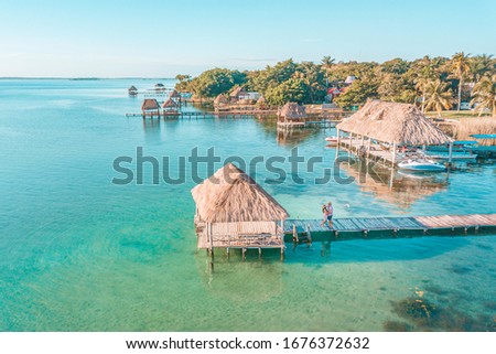 Aerial view of a Couple in Bacalar pier, Riviera Maya, Mexico Royalty-Free Stock Photo #1676372632