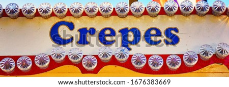 Crepes as letters on a sign.