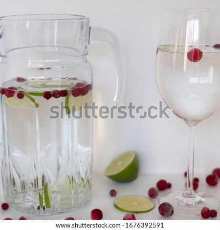 a glass of water with healthy colorful fruits