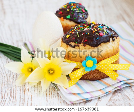 Traditional easter cake and spring flowers on a wood background