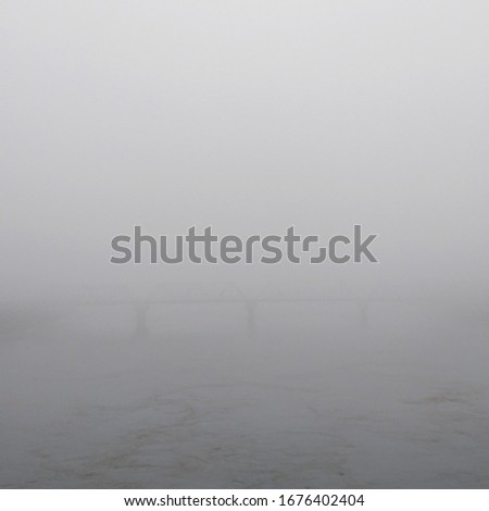 
Sidoarjo, Indonesia - March 29, 2019: The state of the Porong River Bridge covered in thick fog adds to the impression of cold that morning, Indonesia March 29, 2019 Royalty-Free Stock Photo #1676402404