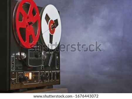 Vintage Reel to reel tape recorder on a grunge background with copy space . A symbol of recording in retro style