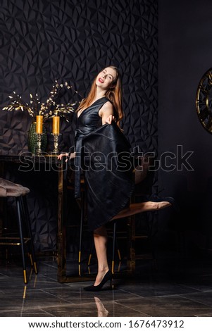 Happy girl having fun at home sitting in chair near bar table