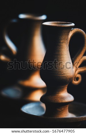 clay candelabr on a black background with hard light
