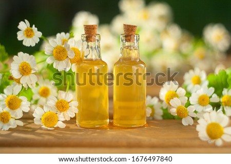 Essence of flowers on a table in a beautiful glass jar
