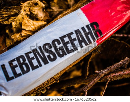 Barrier sign with the inscription in German Lebensgefahr in english Risk of death