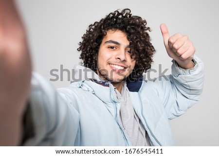 Young curly man take selfie isolated on white background