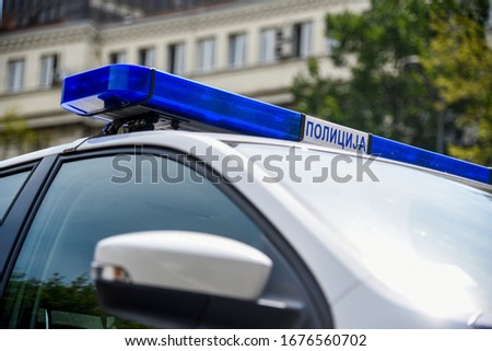 Parked car of serbian police on the street of Belgrade, with a sign POLICE on serbian language