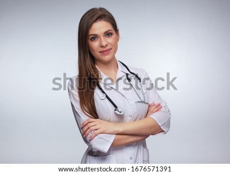 Smiling woman doctor with stethoscope standing with crossed arms. isolated studio portrait. 