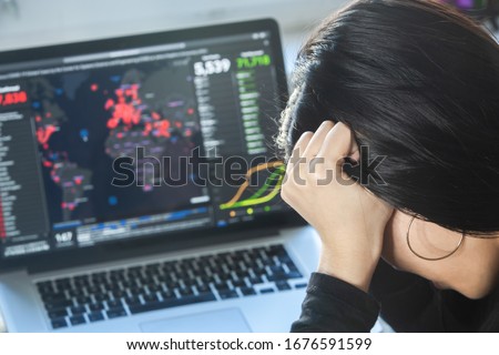 Coronavirus outbreak:  A woman reading news/updates about coronavirus and getting anxiety/depression. Global pandemic. Lockdown mental health. Royalty-Free Stock Photo #1676591599