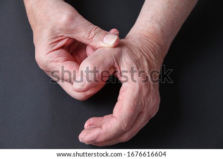 A senior man with soreness in his thumb joint with copy space