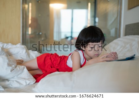 chinese child addicted phone, asian girl playing smartphone, kid use telephone, watching cartoon
