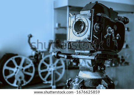 Old style movie projector, still-life, close-up. retro vintage tape video camera. antique film projector Royalty-Free Stock Photo #1676625859