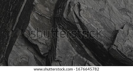 Old Aged Shabby Cliff Face And Divided By Huge Cracks And Layers. Coarse, Rough Gray Stone Or Rock Texture Of Mountains, Background And Copy Space For Text On Theme Geology And Mountaineering. Royalty-Free Stock Photo #1676645782