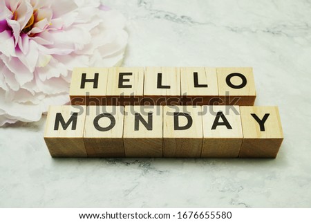 Hello Monday wooden letter alphabet on marble background
