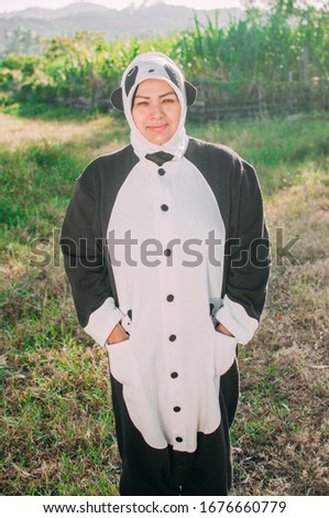 Panda costume holding white paper