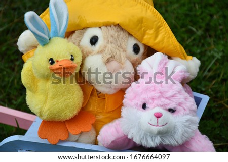 Stuffed animals in a colorful wooden wheelbarrow