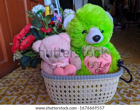 green and pink doll in the basket