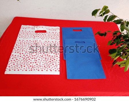 Thank You Bag with D cut blue Non Woven shopping bags on red background, Polypropylene Fabric Bag