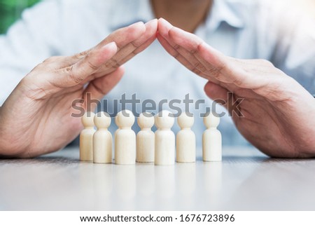 Businessman hand cover man wooden from crowd of employees. People, Business, Human resource management, Life Insurance, Teamwork and leadership Concepts Royalty-Free Stock Photo #1676723896