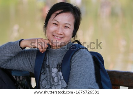 A beautiful woman smiling at the camera inpark
 Royalty-Free Stock Photo #1676726581