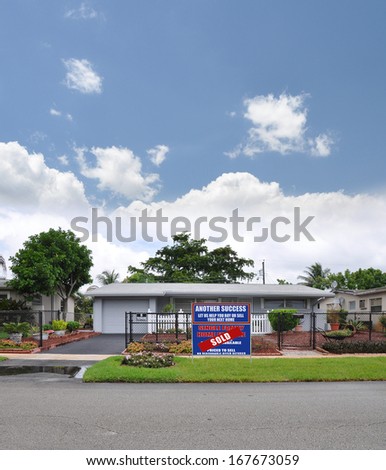 Real Estate For Sale (Another Success Let Us Help You Buy Sell your Next Home) sign front yard lawn suburban ranch style home residential neighborhood usa blue sky clouds