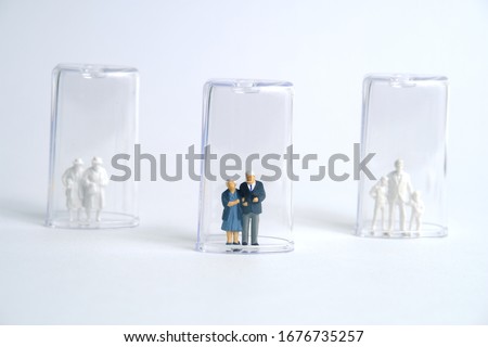 Pandemic corona virus conceptual miniature people photography – social distancing strategy - middle-aged figure on tube isolation