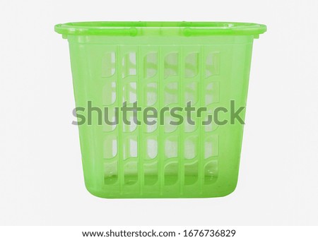 green plastic basket on isolated white background