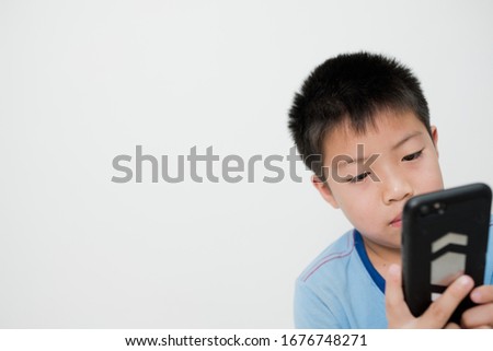 asian chinese boy playing smartphone on white background, kid use phone and play game, addicted game and cartoon, 

