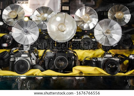 Old folding fan camera flash reflectors with flashbulbs on old cameras taken with shallow depth of field.
