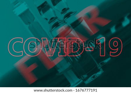 The inscription Covid-19 and Fear on the background of medical products. Abstract image. Soft focus. The concept of fear of the coronavirus pandemic Royalty-Free Stock Photo #1676777191