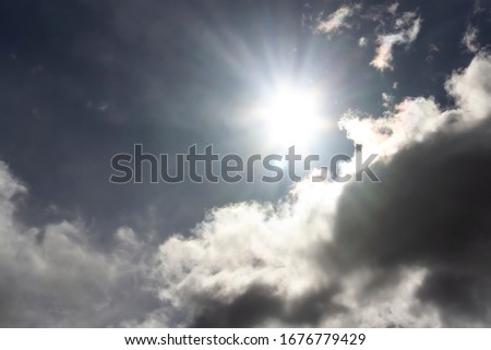Beautiful miracle with clouds in the dark blue sky. Sun light. God light against background