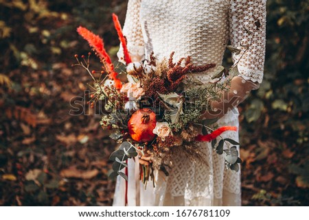 beautiful wedding bouquet in the hands of a girl dressed in a wedding dress