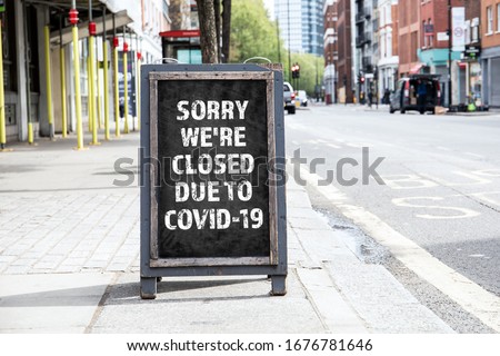 Sorry we're CLOSED due to COVID-19. Foldable advertising poster on the street Royalty-Free Stock Photo #1676781646