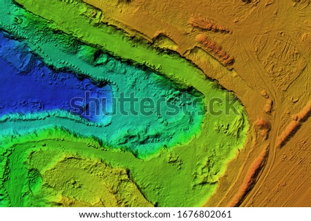 DEM - digital elevation model. GIS product made after proccesing aerial pictures taken from a drone. It shows excavation site with steep rock walls Royalty-Free Stock Photo #1676802061