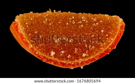 Marmalade slices isolated on a black background close-up.