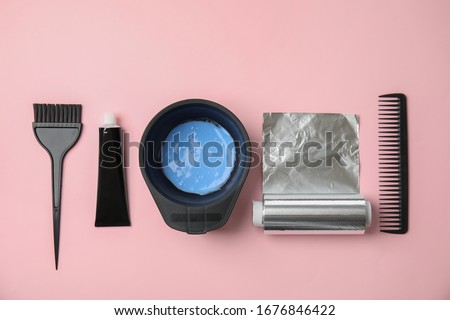 Professional tools for hair dyeing on pink background, flat lay Royalty-Free Stock Photo #1676846422