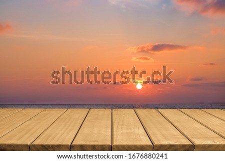 Empty wooden table top with beautiful twilight sky sunset background