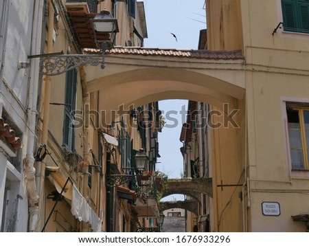 Sanremo – ancient colorful buildings with restaurants and typical shops in Piazza San Siro square. Translation :  San Siro square
