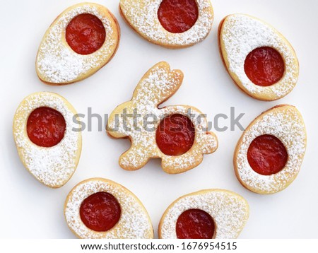 Linzer cookies in Easter shapes, filled with jam and sprinkled with powdered sugar 