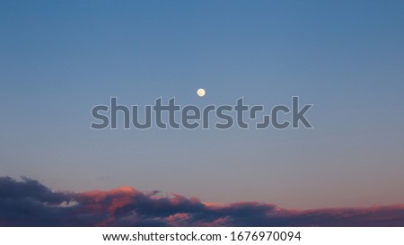 Blue hour full moon in the sky of Calamosca park, Cagliari, Italy 